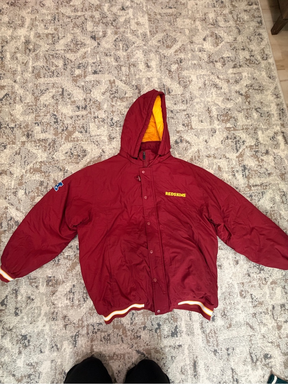 vintage 1990s Washington Redskins NFL Pro Line hooded puffer stadium jacket.